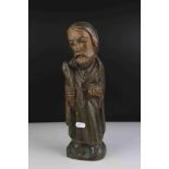 A carved wooden figure of a religious figure.