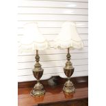 A pair of mid 20th century brass antique style lamps with shades.
