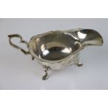 A fully hallmarked sterling silver three legged sauce boat, maker marked for A & J Zimmerman Ltd (