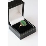 Carved jade 9ct yellow gold ring, the oval pierced carved jade measuring approx 18mm x 11.5mm,