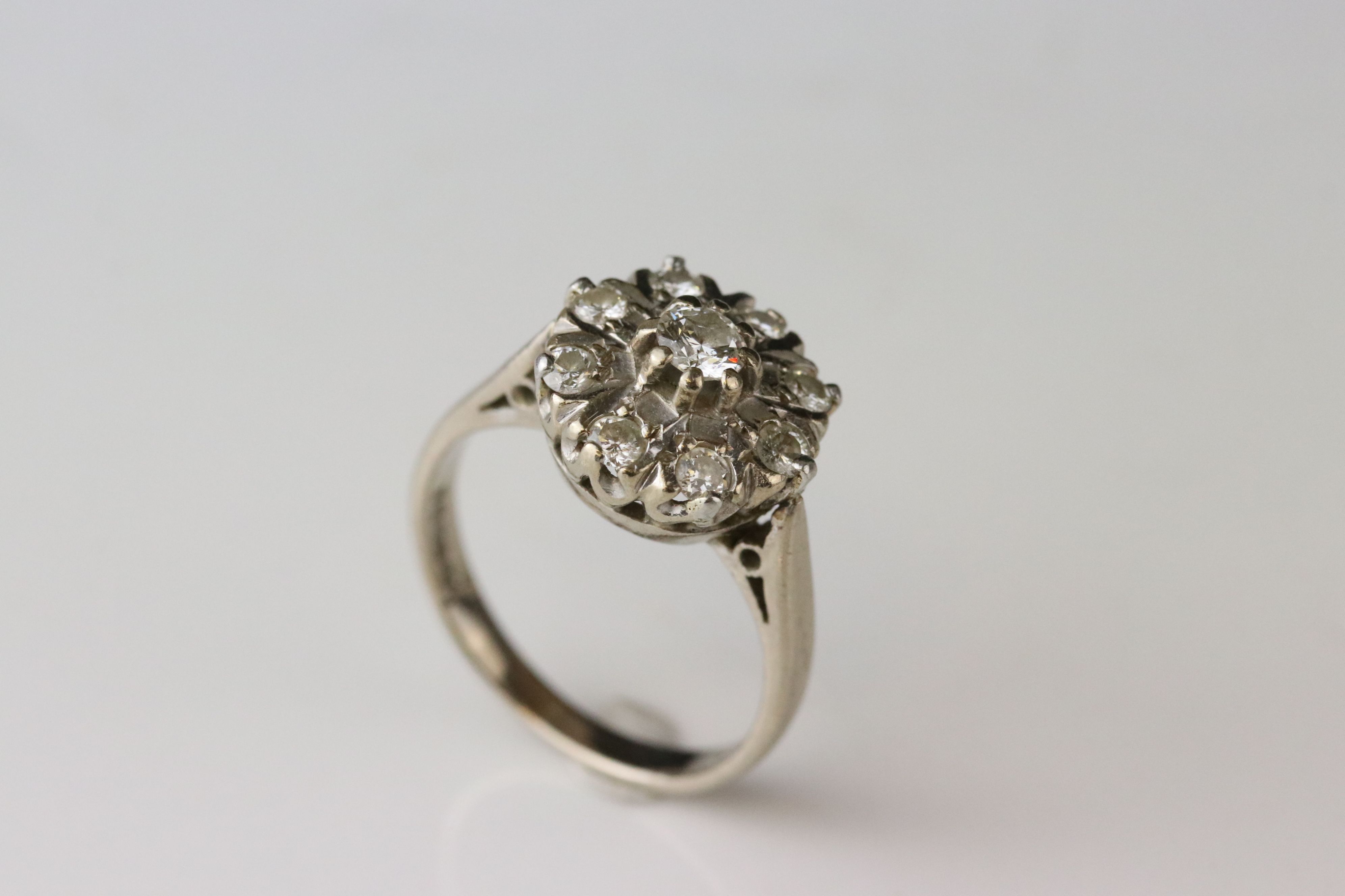 Diamond 18ct white gold cluster ring, principle round brilliant cut diamond weighing approx 0.20