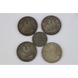 Three Victorian crown coins dated 1890, 1898 and 1899, a George V crown dated 1935 and a Victorian