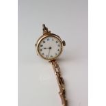 9ct rose gold cased wristwatch, white enamel dial, black Arabic numerals, gold poker hands, broken
