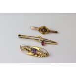 Three Edwardian 9ct gold brooches comprising pink tourmaline sprig brooch; amethyst stray brooch and