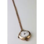 Early 20th century 9ct gold cased wristwatch, white enamel dial with black Roman numerals and