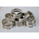 Nine silver napkin rings to include a set of five, engine turned decoration, blank rectangular