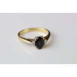 Sapphire and diamond 18ct yellow gold ring, the oval mixed cut blue-black sapphire measuring