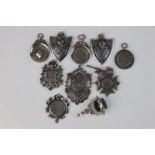 A collection of nine fully hallmarked sterling silver watch fob medallions together with a silver