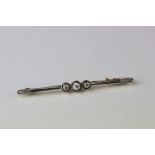 Circa 1930s diamond yellow gold and platinum set bar brooch, three graduated small round brilliant