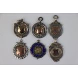 A collection of six fully hallmarked sterling silver watch fob medallions.
