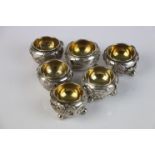 A set of six oriental decorative white metal (tests silver) salts with gilt interior.