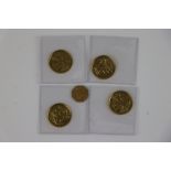 A small collection of British gold coins to include California gold rush 1/4 dollar and an Isle of