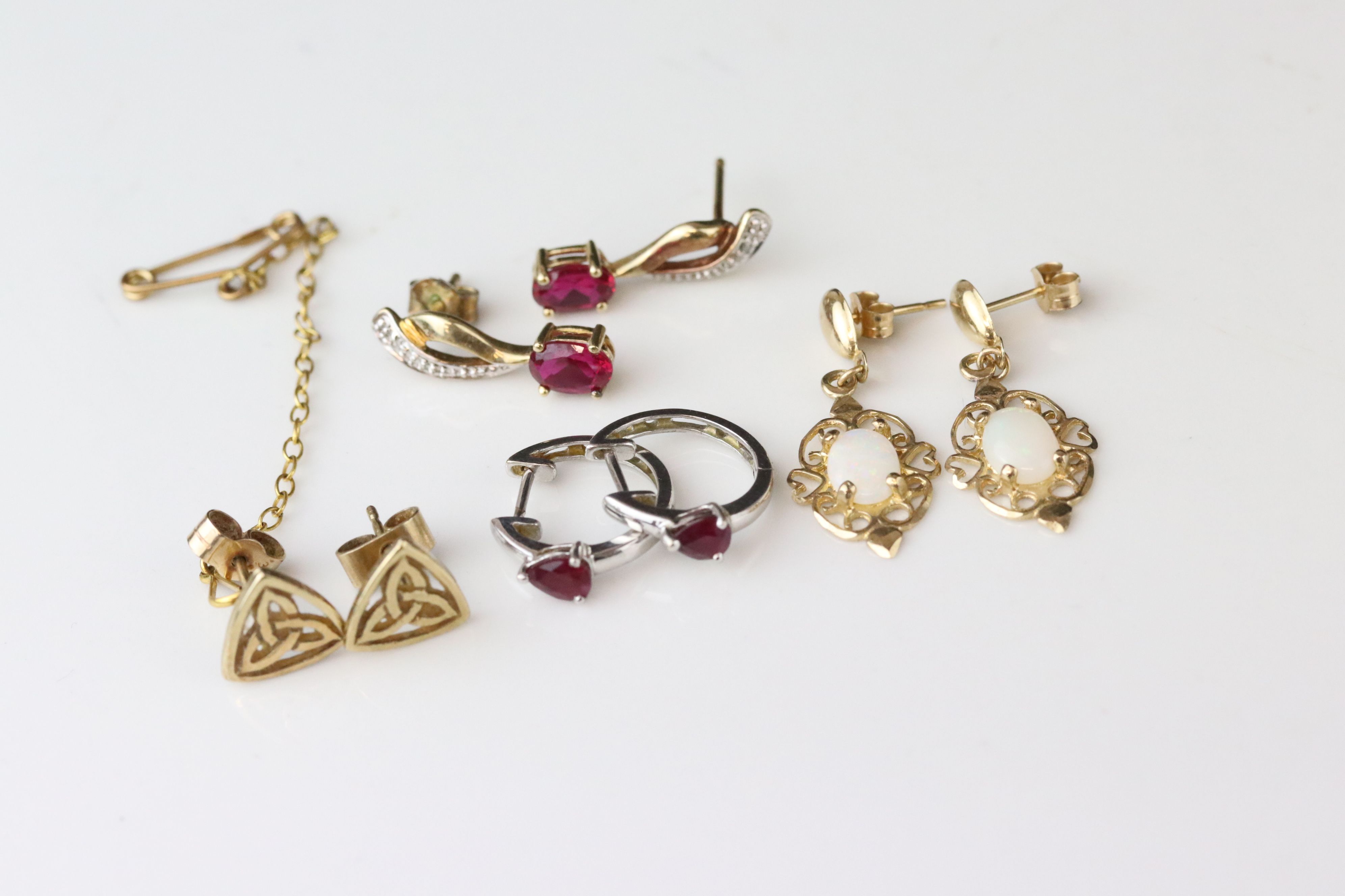 Four pairs of 9ct gold drop and stud earrings to include opals and rubies (4)