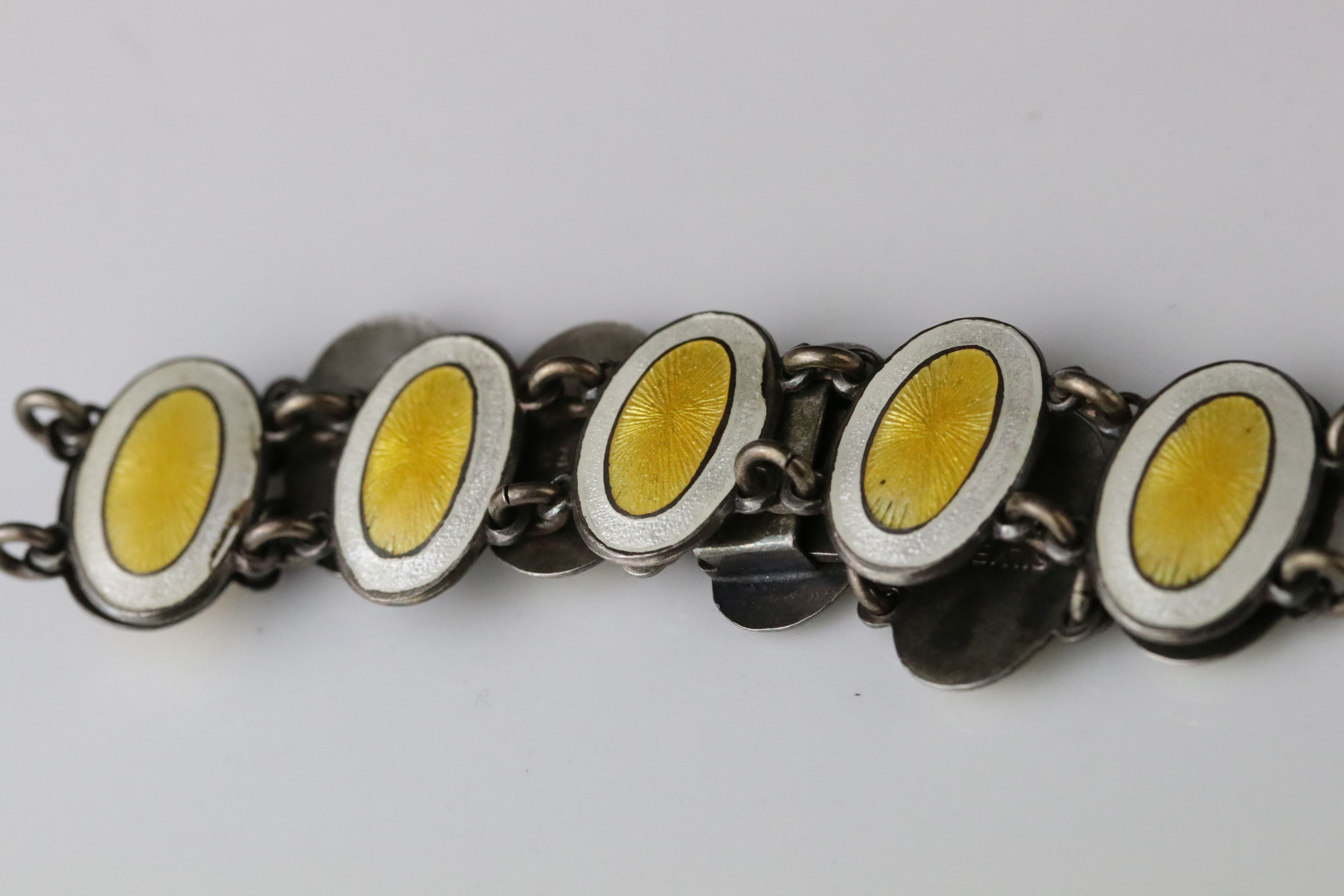 Early 20th century enamelled silver panel bracelet, eleven oval yellow and white enamelled panels, - Image 3 of 6