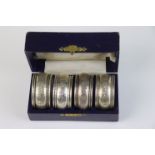 A fully hallmarked sterling silver cased set of four napkin rings, maker marked for William