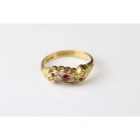 Early 20th century ruby and diamond 18ct yellow gold scroll head ring, two small round mixed cut