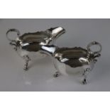 A fully hallmarked sterling silver pair of early Edwardian three legged sauce boats, maker marked