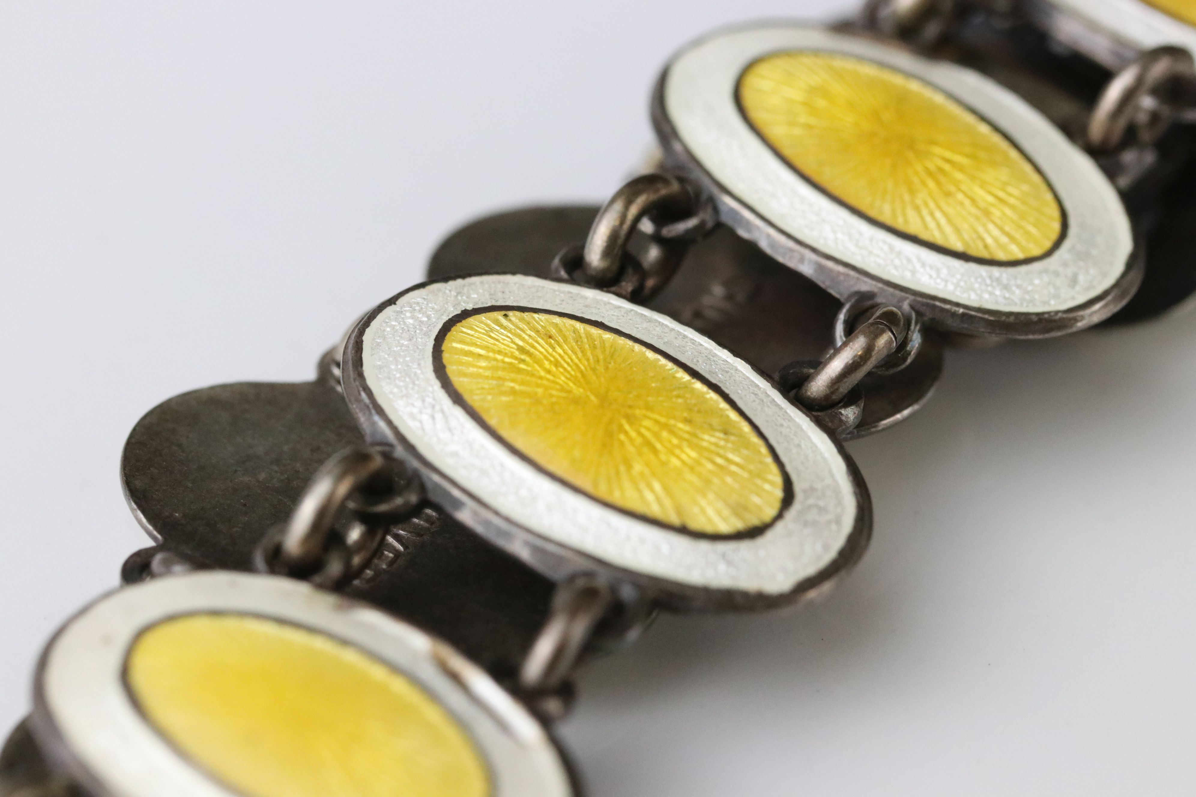 Early 20th century enamelled silver panel bracelet, eleven oval yellow and white enamelled panels, - Image 4 of 6