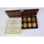 A cased Danbury Mint fully hallmarked silver gilt set of twelve ingots featuring the arms of the