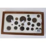 A framed collection of antique medallions, early milled and hammered coins to include a Queen