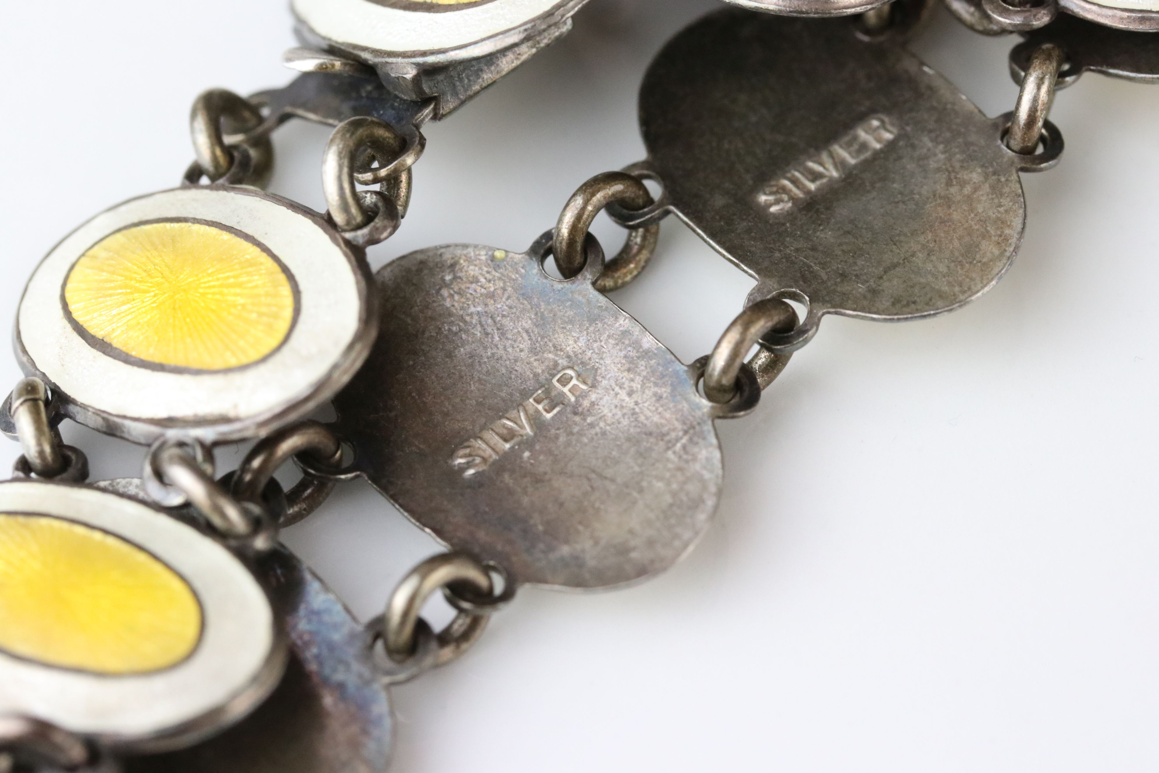 Early 20th century enamelled silver panel bracelet, eleven oval yellow and white enamelled panels, - Image 5 of 6