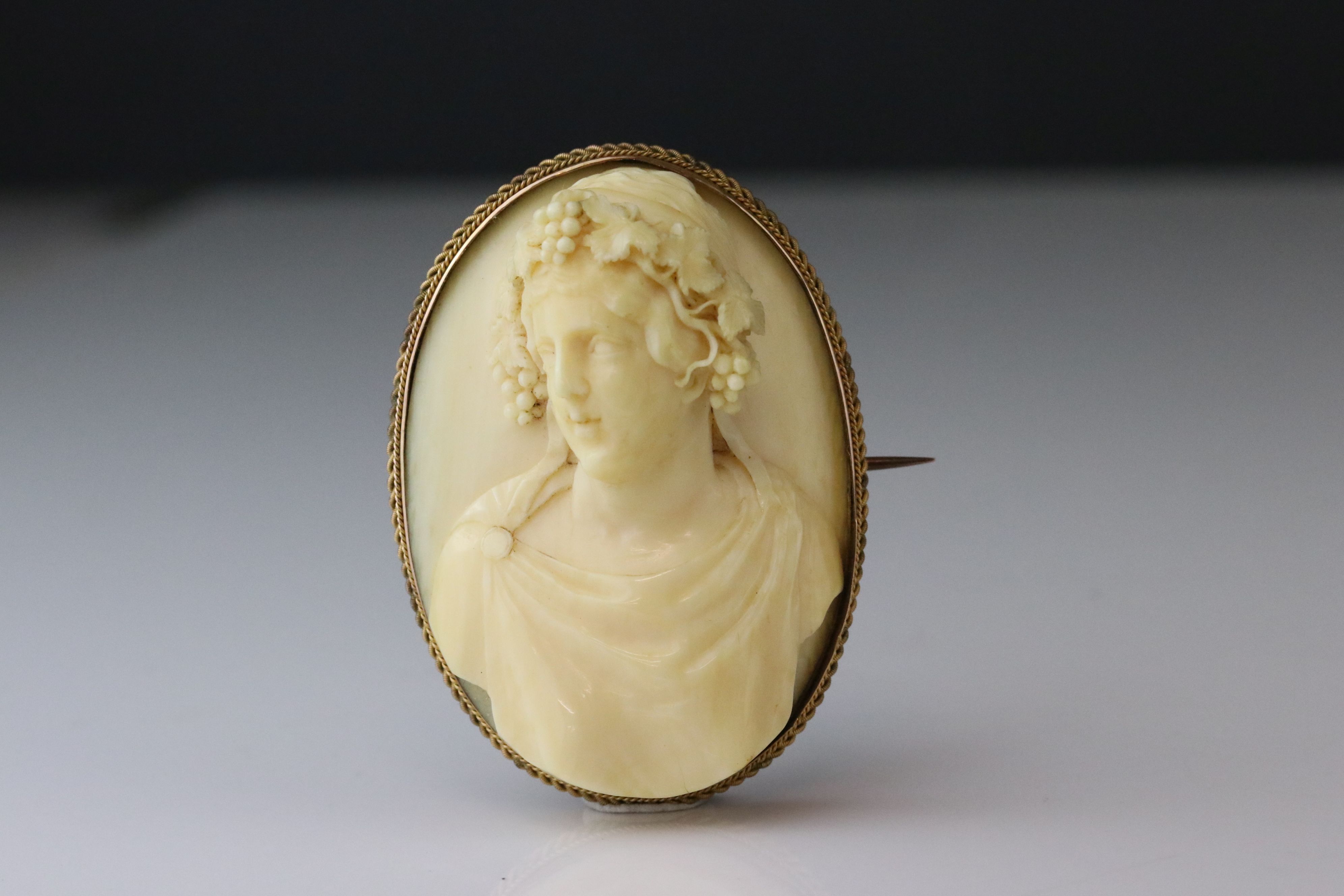 Victorian ivory cameo unmarked yellow gold oval brooch, the ivory cameo depicting female bust with