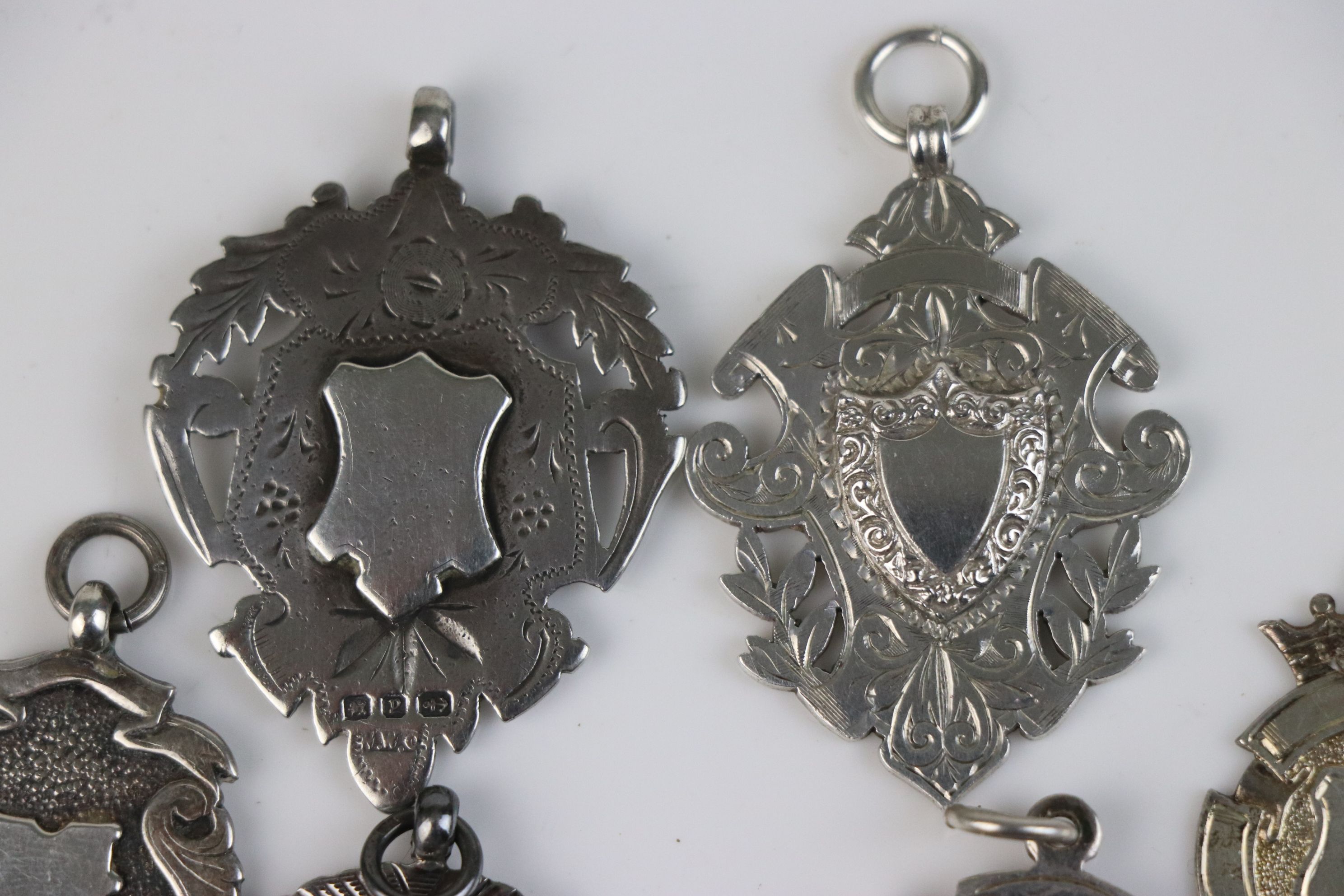 A collection of seven fully hallmarked sterling silver watch fob medallions. - Image 2 of 6