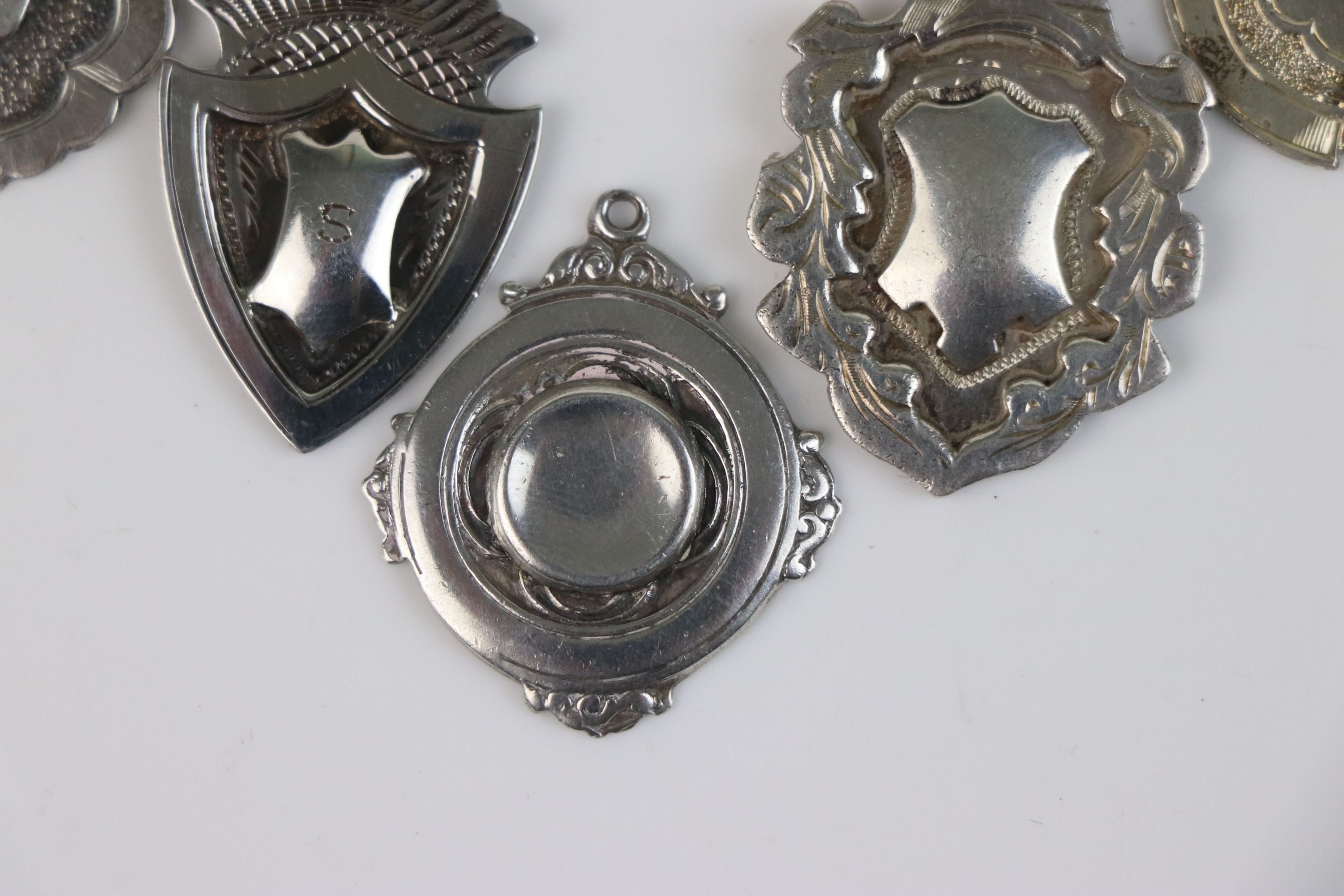 A collection of seven fully hallmarked sterling silver watch fob medallions. - Image 4 of 6