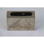 A Chinese sterling silver matchbox holder with engraved bamboo decoration to the front.