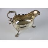 George III silver sauce boat raised on three hoof feet with stylised foliate shoulders, engraved