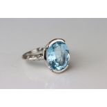 Topaz and diamond ring, hallmarks rubbed, assessed as 18ct white gold, the oval mixed cut topaz