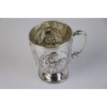 A fully hallmarked sterling silver mug with handle to the opposite a monogram panel, finely embossed