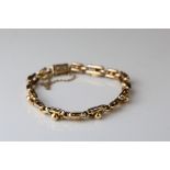 Edwardian yellow metal fancy link bracelet, tongue and box patented clasp, safety chain, length