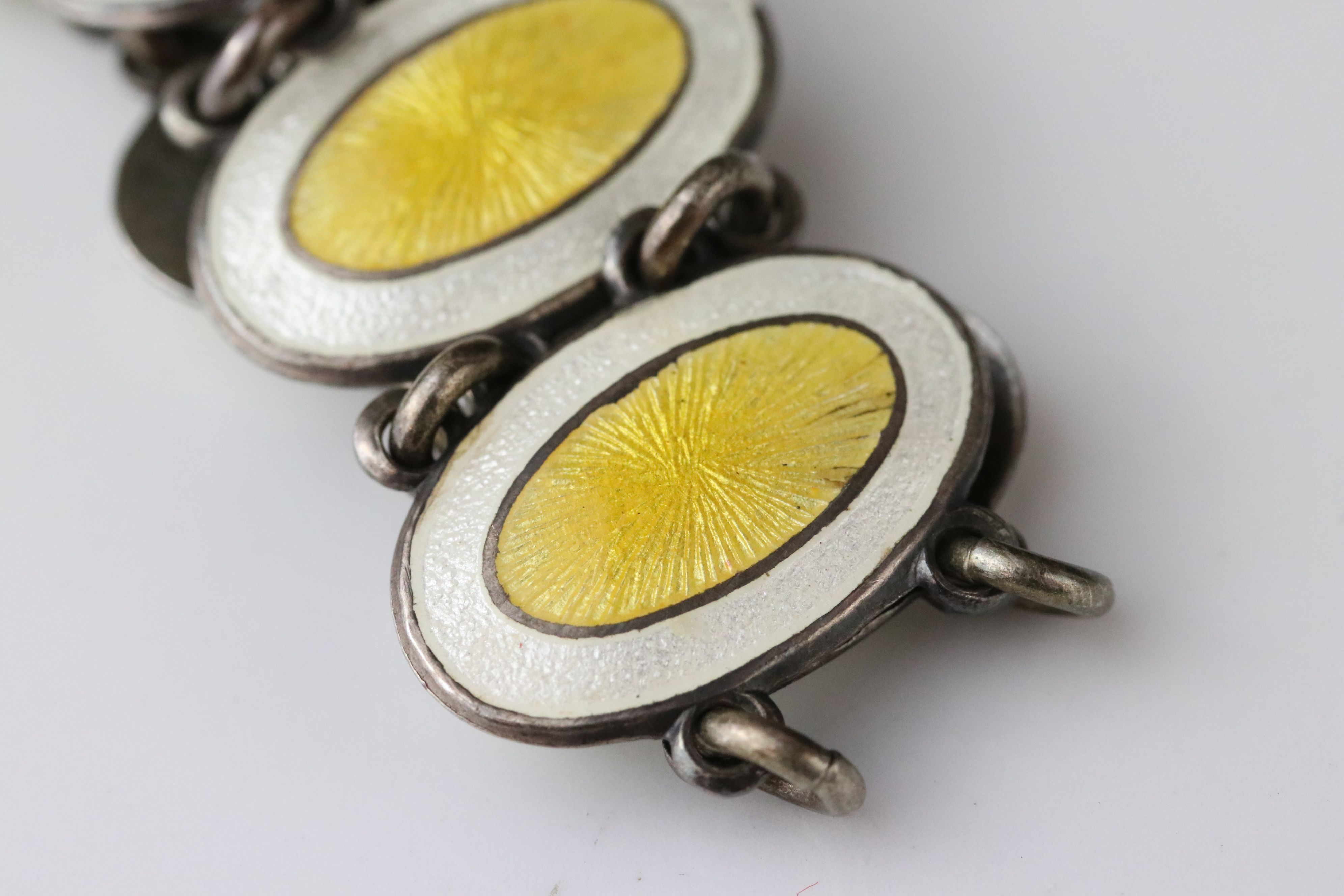 Early 20th century enamelled silver panel bracelet, eleven oval yellow and white enamelled panels, - Image 6 of 6