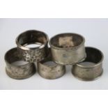 A group of five fully hallmarked sterling silver napkin rings, various makers and assay marks.