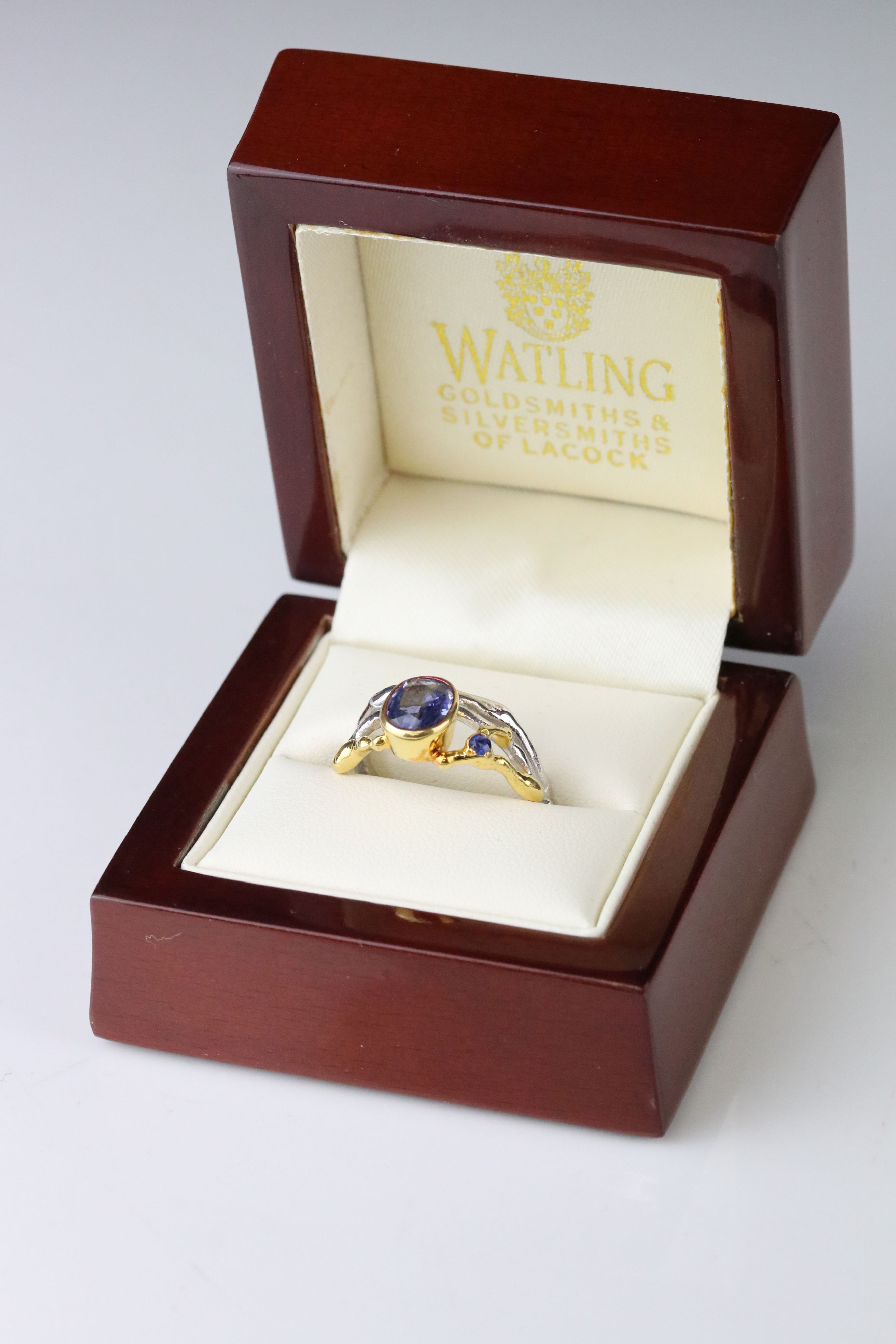 Sapphire 18ct yellow and white gold ring, the principle oval mixed cut blue sapphire measuring