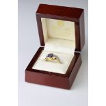 Sapphire 18ct yellow and white gold ring, the principle oval mixed cut blue sapphire measuring