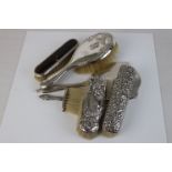 Silver dressing table hand mirror together with silver backed brush, three silver backed clothes