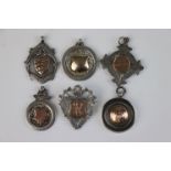 A collection of six fully hallmarked sterling silver watch fob medallions.