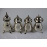 Three silver pepperettes of baluster from raised on four feet, hallmarks rubbed and one silver