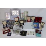 A large collection of mixed coins to include cased crowns, a Royal Mint Year 2000 deluxe proof