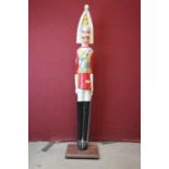 A large carved wooden painted figure of a guardsman, approx 134cm.