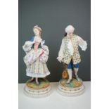 A pair of Continental bisque figures lady and gent in 18th century costume Makers mark AM 35 CM