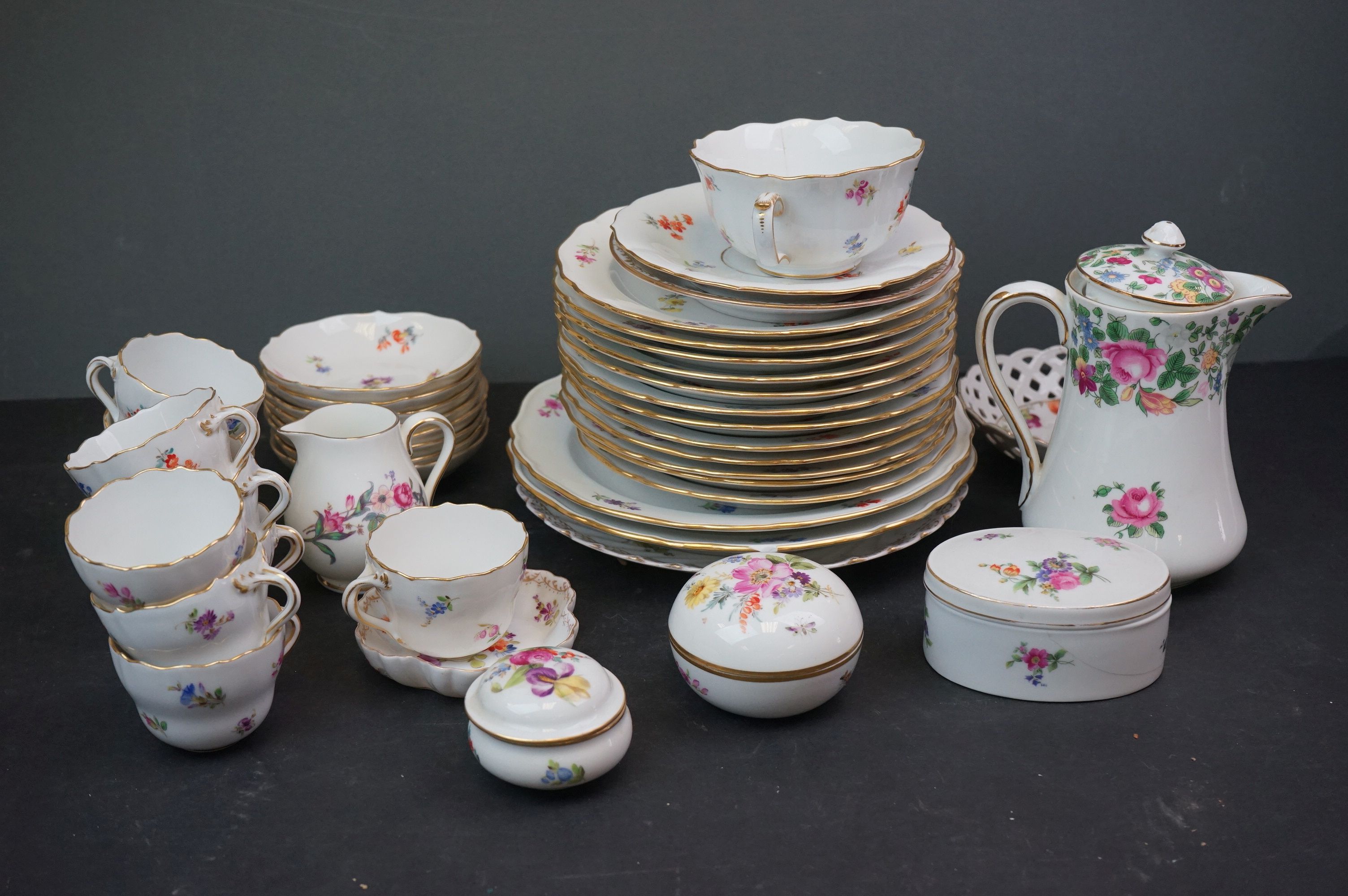 A collection of Meissen and Dresden porcelain to include plates, cups and dishes.