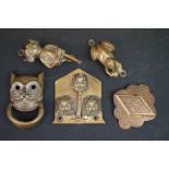 A small collection of brass door knockers to include a frog and a pixie.