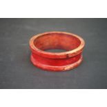 An African traders bangle c.1850, the ivory bangle stained red and faintly inscribed.