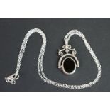 Silver revolving pendant necklace, set with onyx and mother of pearl