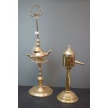 A brass Taper candle holder together with a brass pourer, possibly ecclesiastical .