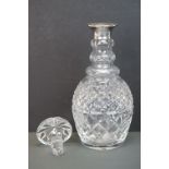 A fully hallmarked sterling silver collared cut glass decanter.