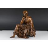 A bronze spelter figure of a seated lady of classical form.